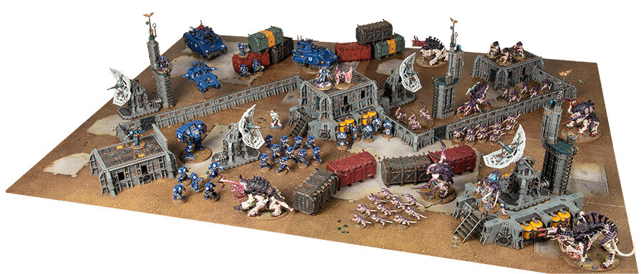 This Strike Force battlefield uses several Battlezone kits to create a lot of visual variety. It has line of sight blocking pieces in the centre of the battlefield, in each corner, and mid-way along each long edge of the battlefield, as well as obstacles and scatter pieces of scenery that provide cover running through the gaps. It provides a good matched play experience and is one that players can aspire to as their terrain collection grows.